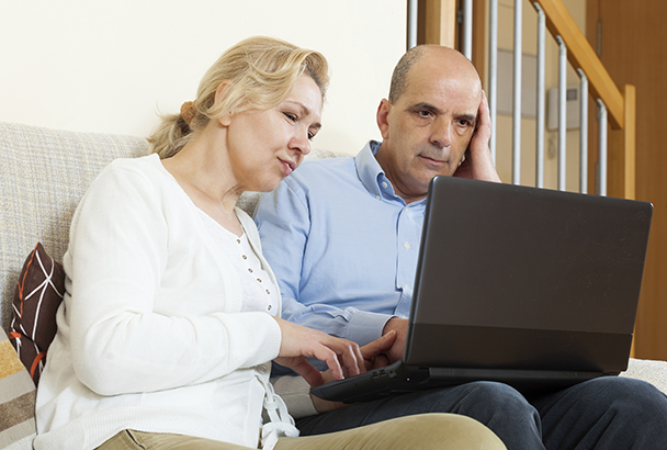 mature couple using laptop